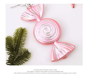 Detailed view of pink candy-shaped Christmas ornament with silver glitter accents