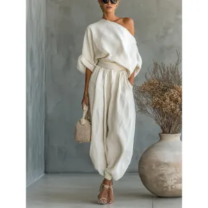 Elegant off-white cotton linen set with one-shoulder top and loose lantern pants