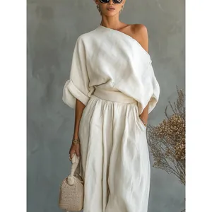 Chic cream cotton linen two-piece set featuring one-shoulder top and wide-leg lantern pants