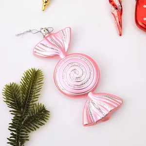 Pink candy-shaped Christmas tree ornament with silver glitter swirl design