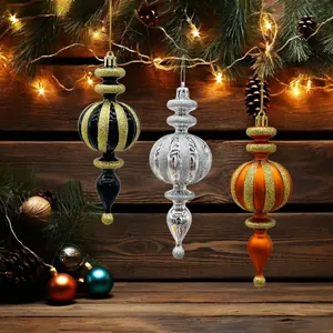 Set of three assorted decorative Christmas ornaments hanging in front of a wooden wall