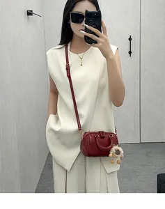 Elegant women's dark red Boston pillow bag styled in a trendy crossbody outfit