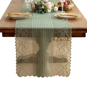 Elegant sage green French lace table runner with hollow floral design for dining room decor.