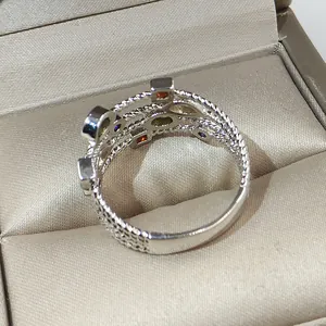 Multicolored zirconia braided ring in silver-plated copper presented in a gift box.