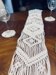 Detailed view of handwoven macrame table runner with geometric diamond patterns
