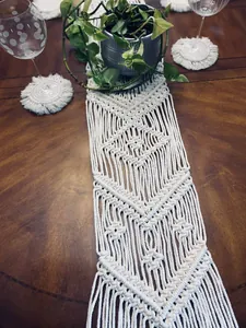 Detailed close-up of a handcrafted Nordic macrame table runner on a wooden table