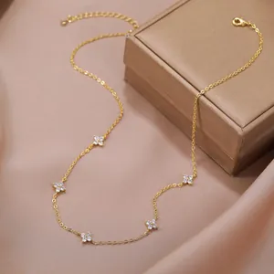 Close-up view of an elegant 18K gold-plated clover necklace with sparkling cubic zirconia