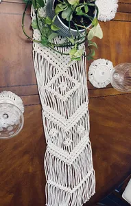Hand-woven cream macramé table runner with elegant fringe for bohemian home decor