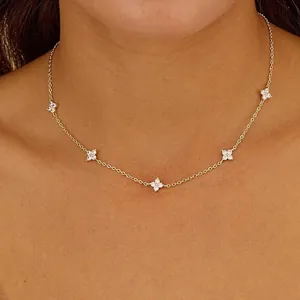 Elegant 18K gold plated clover necklace with sparkling zircons worn on the neck.