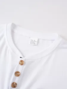 Detail of the neckline and button placket on a men's white casual round neck T-shirt