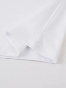 Macro view of high-quality double-stitched hem on a white men's cotton T-shirt