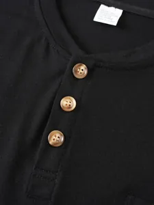 Macro view showing neckline and buttons of a men's black casual crew neck t-shirt