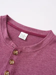 Close-up of men's casual round neck shirt with three-button placket and size label
