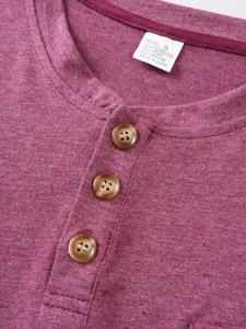 Detailed macro view of burgundy casual Henley shirt neckline with buttons and tag