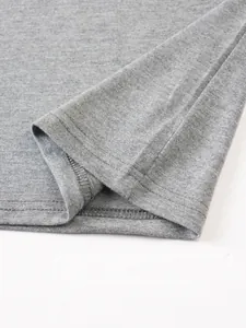 High-quality close-up showing neat hem stitching on a men's gray cotton casual T-shirt.