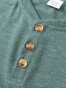 Detailed view of three brown buttons on a heather green casual men's T-shirt