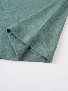 Close-up of the neat double-needle stitching on a green marl fabric men's T-shirt hem.