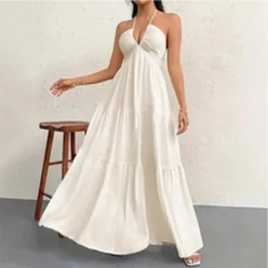 Detailed view of the layered skirt and halter neck design on a white maxi summer dress