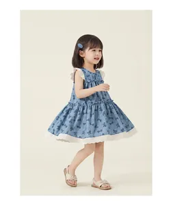 Detailed side view of girl's blue sleeveless dress with bow print and white lace trim