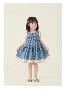 Little girl wearing a blue butterfly print sleeveless dress with white lace details.