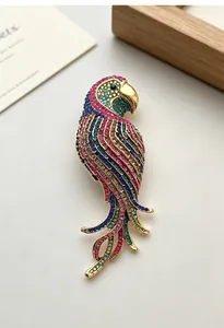 Close-up of a retro colorful crystal parrot brooch with vibrant rhinestones on gold base