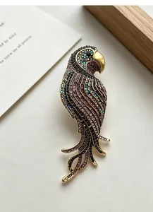 Detail view of a vintage rhinestone parrot brooch with sparkling multicolored crystals