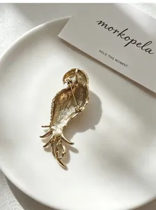Back view of vintage gold parrot brooch showing secure pin closure mechanism