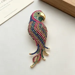 Vintage colorful rhinestone parrot brooch with vibrant crystals on elegant gold plating
