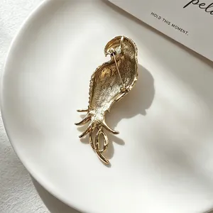 Detailed back view of a vintage gold-tone parrot brooch featuring a secure pin closure mechanism