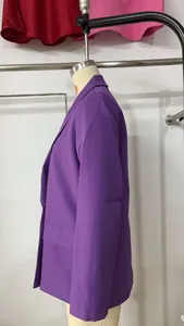 Side profile detail of a purple casual double-breasted loose fit blazer on a mannequin
