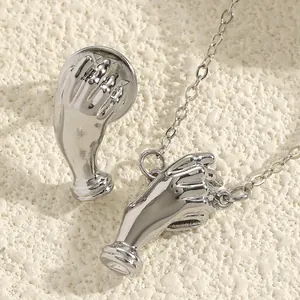 Close-up detail of silver hand-shaped brooch set designed to hold mini bouquets now