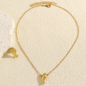 Detail view of a golden hand-shaped pendant necklace with intricate finger textures.