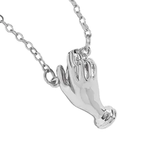 Close-up of a silver hand-shaped pendant with a polished metallic finish on a chain