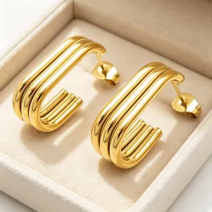 Close-up of 18K gold plated multi-layer stainless steel oval hoop earrings