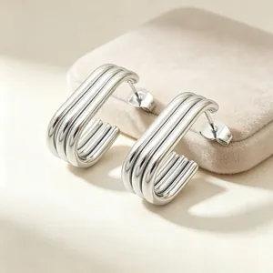 Detailed view of silver multi-layer stainless steel oval hoop earrings for women