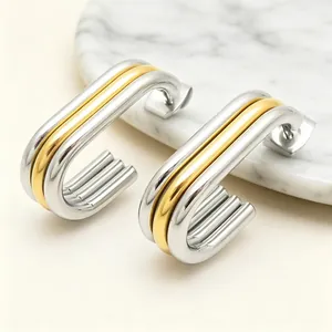Macro view of modern two-tone oval multilayer earrings with a high polished finish.