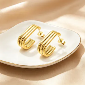 Detailed close-up of gold-plated multi-layer oval stainless steel hoop earrings