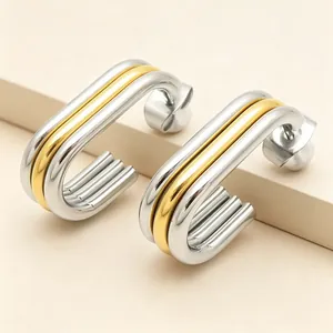 Detail of multi-layer oval earrings with gold and silver toned stainless steel finish