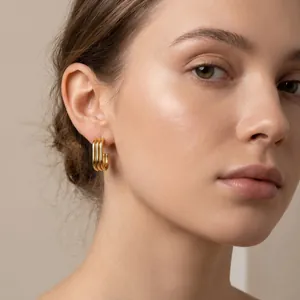 Detail view of triple-layered 18K gold plated stainless steel oval hoop earrings