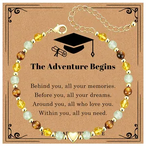 Close-up of beaded graduation bracelet with tiger eye stones and heart charm on gift card