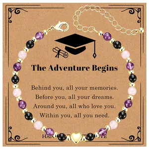 Detailed view of beaded graduation bracelet with heart charm on gift card
