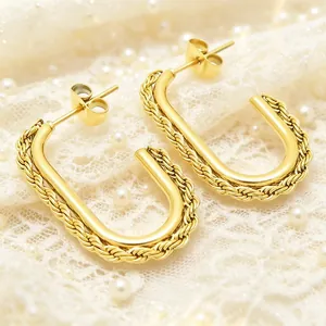 Elegant gold stainless steel U-shaped earrings with a twisted rope edge detail on lace