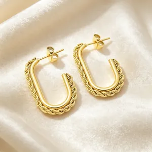 Macro detail of the twisted rope texture on gold-plated stainless steel earrings.