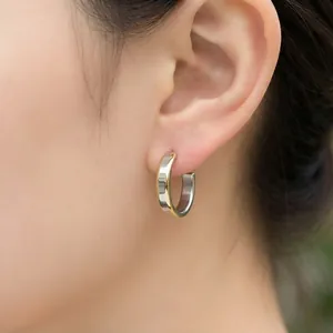 Minimalist two-tone stainless steel C-shaped hoop earrings for a stylish commute look