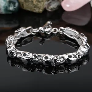 Detailed macro view of a silver titanium steel skull link bracelet for men jewelry