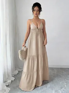 Elegant beige spaghetti strap tiered maxi dress for women with a vacation style
