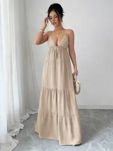 Full length view of elegant beige tiered spaghetti strap maxi dress on a professional model