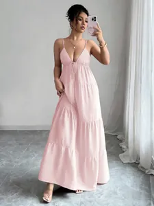 Detailed view of an elegant pink spaghetti strap tiered maxi dress for women.