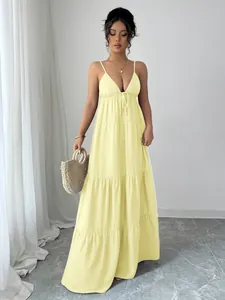 Elegant full-length view of a pale yellow tiered spaghetti strap maxi dress for women
