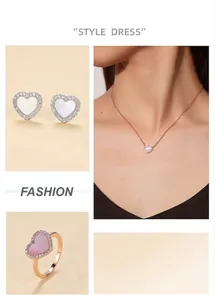Detailed showcase of heart-shaped jewelry set featuring pink shell and crystal inlay